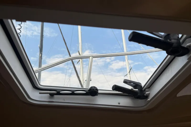 Slide: The Image of 2017 Ranger Tugs R-23 boat hatch view with sky and mast. - 28