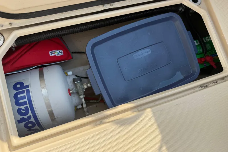 Slide: The Image of Storage compartment of 2017 Ranger Tugs R-23 with propane tank and container. - 31