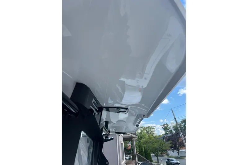 Slide: The Image of 2022 Sea Pro 239 Sport boat canopy with clear sky background. - 14