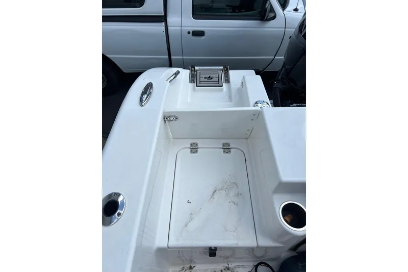 Slide: The Image of 2022 Sea Pro 239 Sport boat deck with storage compartments and cup holders. - 17