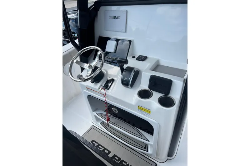 Slide: The Image of 2022 Sea Pro 239 Sport boat console with steering wheel and controls. - 18