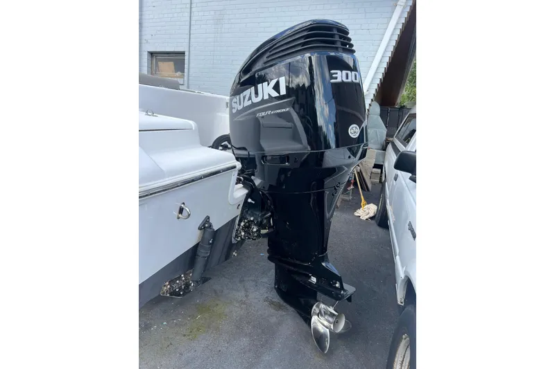 Slide: The Image of 2022 Sea Pro 239 Sport with Suzuki 300 outboard motor, parked outdoors. - 4