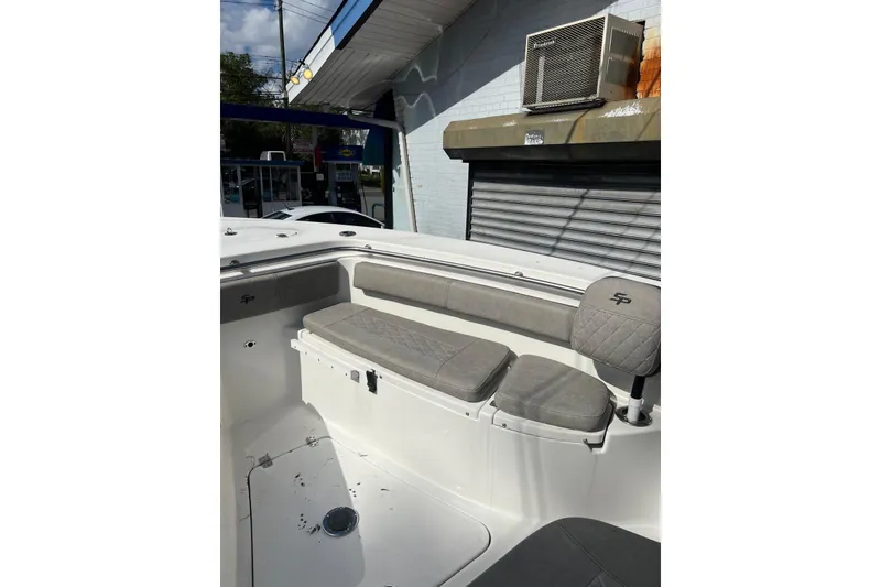 Slide: The Image of 2022 Sea Pro 239 Sport boat interior with gray seating and SP logo. - 9