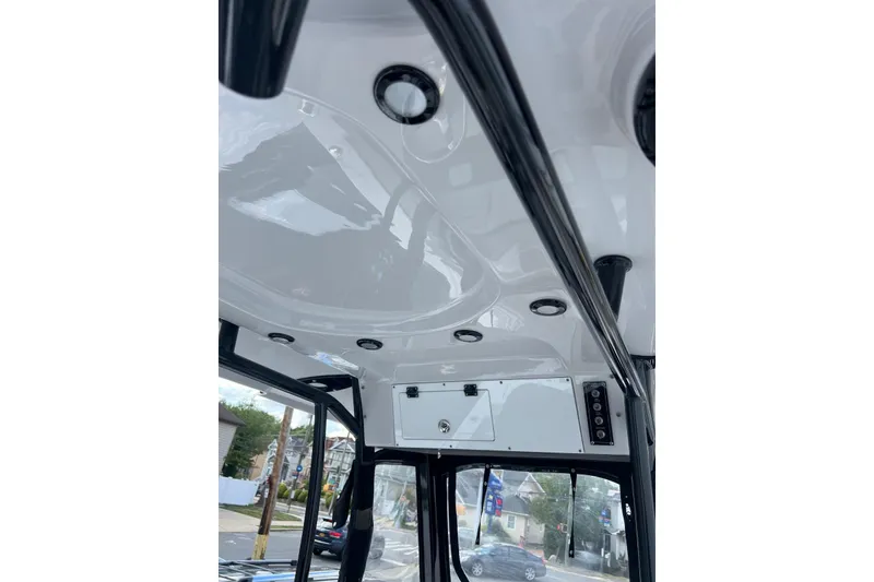 Slide: The Image of 2022 Sea Pro 239 Sport boat interior ceiling with lights and control panel. - 11