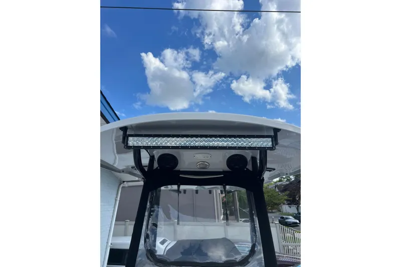 Slide: The Image of 2022 Sea Pro 239 Sport boat with T-top and LED light bar under a blue sky. - 13