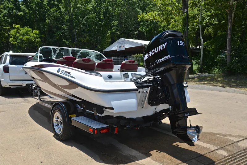 Slide: The Image of 2012 Triton 190 boat with Mercury 150 engine on trailer, parked outdoors. - 12
