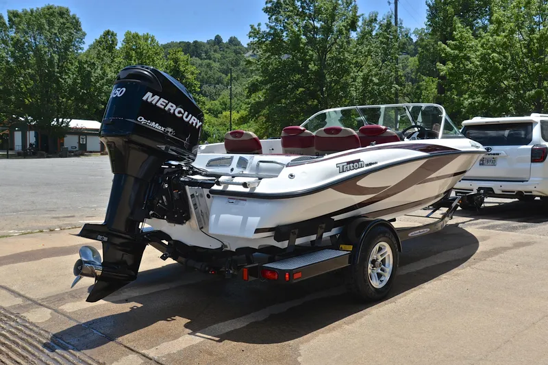 Slide: The Image of 2012 Triton 190 boat with Mercury engine on trailer, parked outdoors. - 14