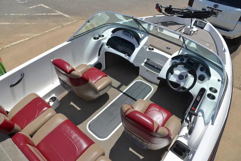 Slide: The Image of 2012 Triton 190 boat interior with red and beige seats, steering wheel, and dashboard. - 21