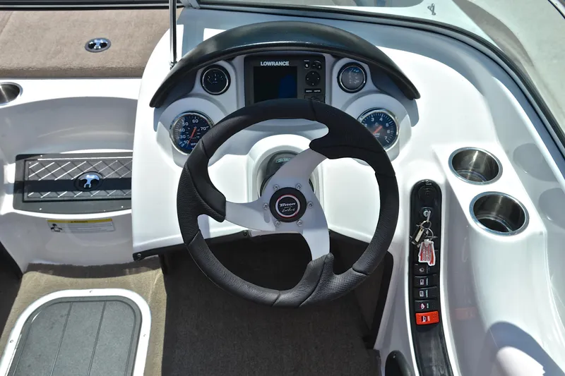 Slide: The Image of 2012 Triton 190 boat dashboard with steering wheel, gauges, and control panel. - 24