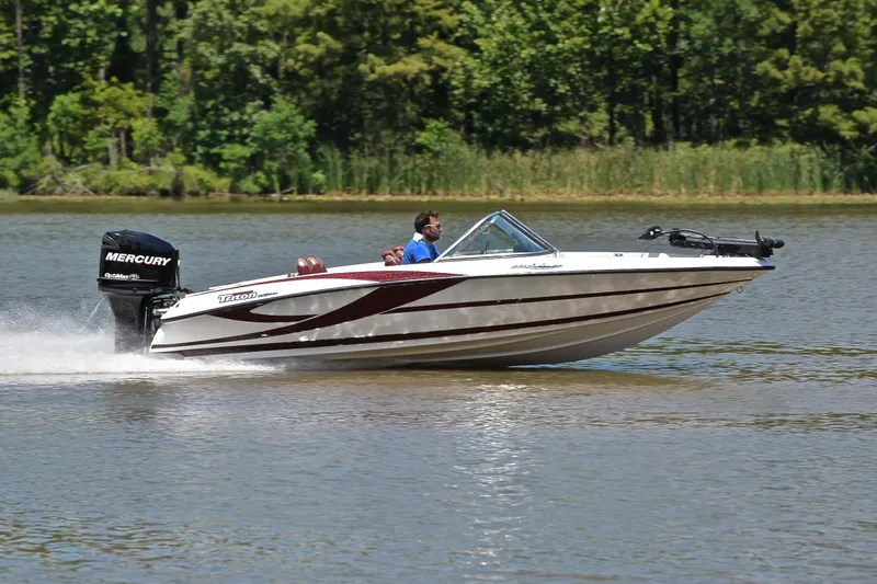 Slide: The Image of 2012 Triton 190 boat cruising on a lake with Mercury outboard motor. - 3