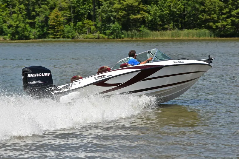 Slide: The Image of 2012 Triton 190 boat speeding on a lake with Mercury outboard motor. - 5