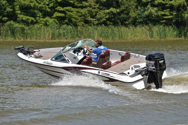 Slide: The Image of 2012 Triton 190 boat cruising on a lake with a Mercury 150 engine. - 6