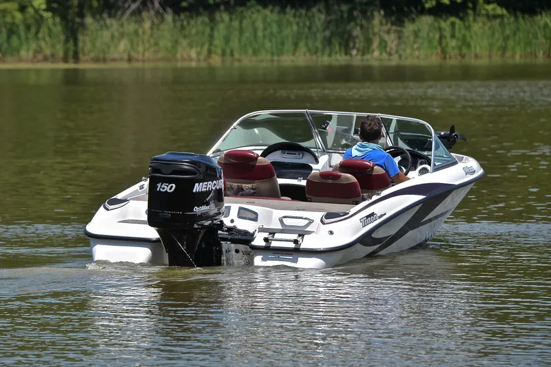 Slide: The Image of 2012 Triton 190 boat with Mercury 150 engine cruising on a calm lake. - 8