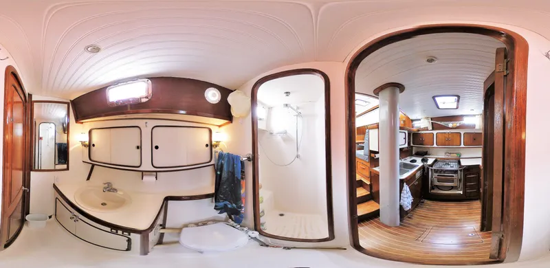 Slide: The Image of 1980 Gulfstar 47 Sailmaster cabin with wooden interior and cozy bed. - 10