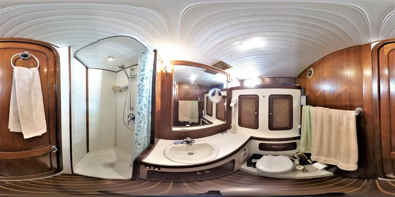 Slide: The Image of 1980 Gulfstar 47 Sailmaster bathroom with wood accents and modern fixtures. - 11