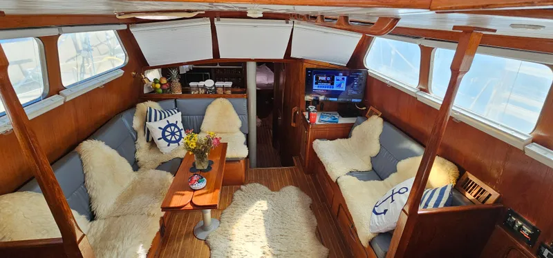Slide: The Image of Interior of 1980 Gulfstar 47 Sailmaster with cozy seating, TV, and nautical decor. - 4