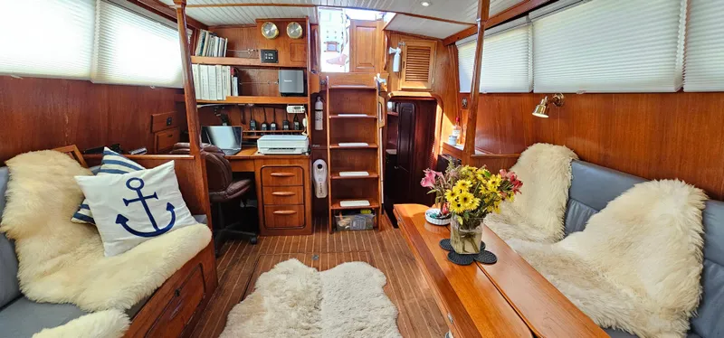Slide: The Image of Cozy interior of 1980 Gulfstar 47 Sailmaster with plush seating and nautical decor. - 5