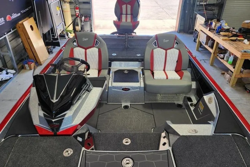 Slide: The Image of 2026 Ranger Z520R Cup-Equipped boat interior with red and gray seating in a garage. - 11