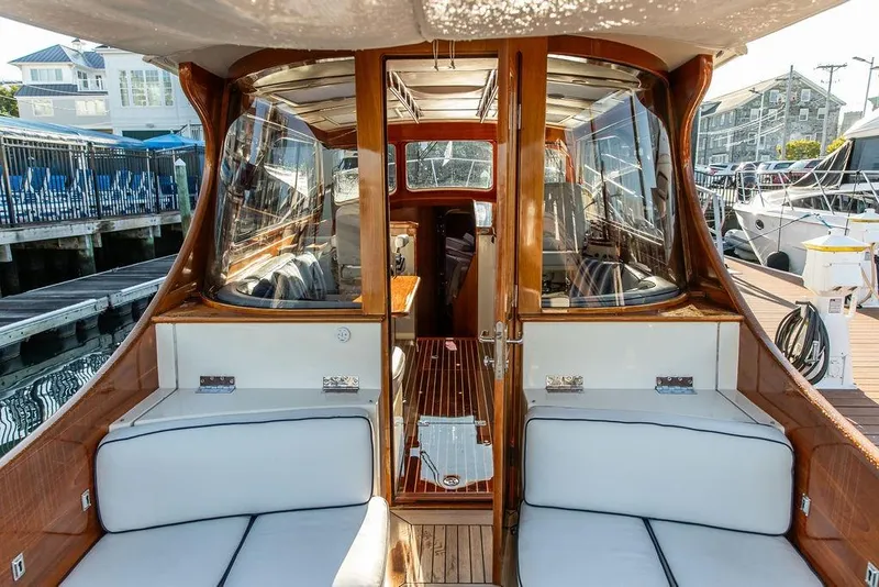 Slide: The Image of Helm of 2005 Hinckley Talaria 44 with navigation screens and wooden steering wheel. - 13