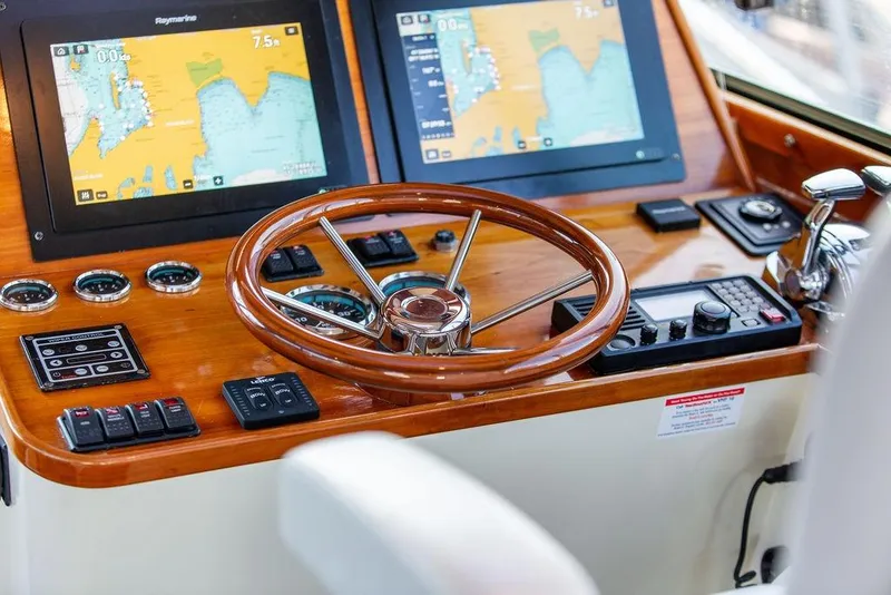 Slide: The Image of Helm of 2005 Hinckley Talaria 44 yacht with navigation screens and captain's chair. - 14