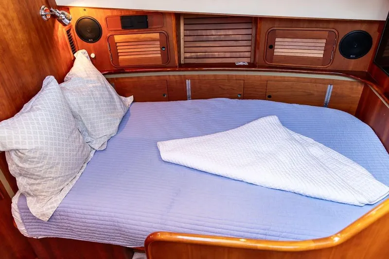 Slide: The Image of Luxurious 2005 Hinckley Talaria 44 yacht cabin with wood paneling and a large TV. - 27