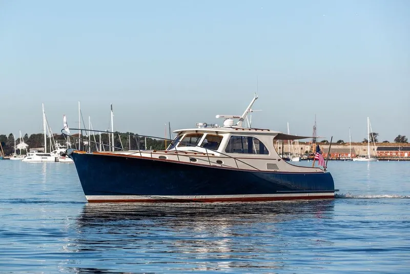 Slide: The Image of 2005 Hinckley Talaria 44 yacht cruising on calm waters with clear sky. - 3