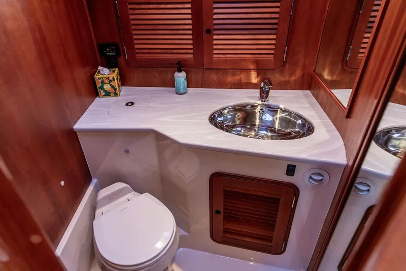 Slide: The Image of Hinckley Talaria 44 2005 yacht shower with wooden seat and chrome fixtures. - 31