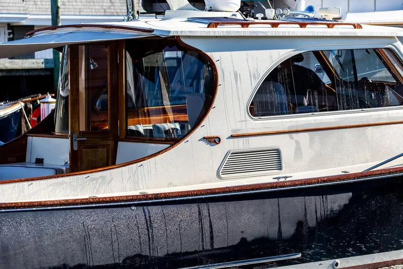 Slide: The Image of 2005 Hinckley Talaria 44 yacht cruising on calm waters with American flag. - 6