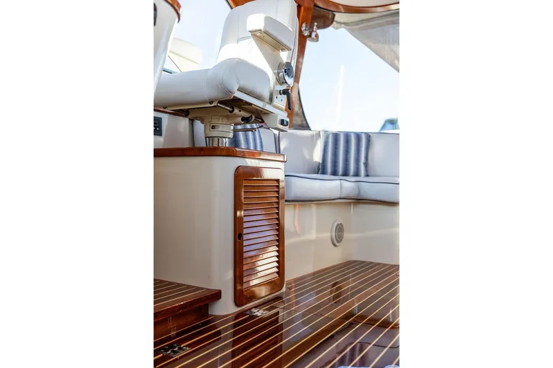 Slide: The Image of Luxury seating area on a 2005 Hinckley Talaria 44 yacht with wooden accents. - 16