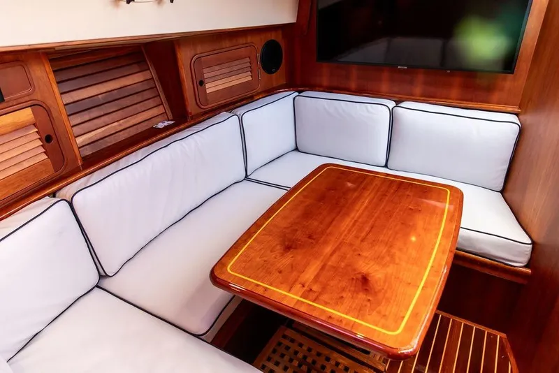 Slide: The Image of Luxurious interior of 2005 Hinckley Talaria 44 yacht with elegant wood finish and cushioned seating. - 21