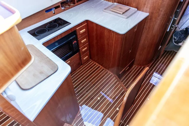 Slide: The Image of Cozy cabin interior of 2005 Hinckley Talaria 44 yacht with blue bedding. - 26