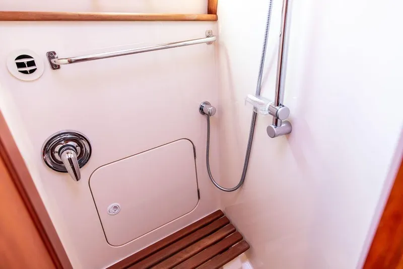 Slide: The Image of Interior of 2005 Hinckley Talaria 44 yacht shower with skylight and porthole. - 32