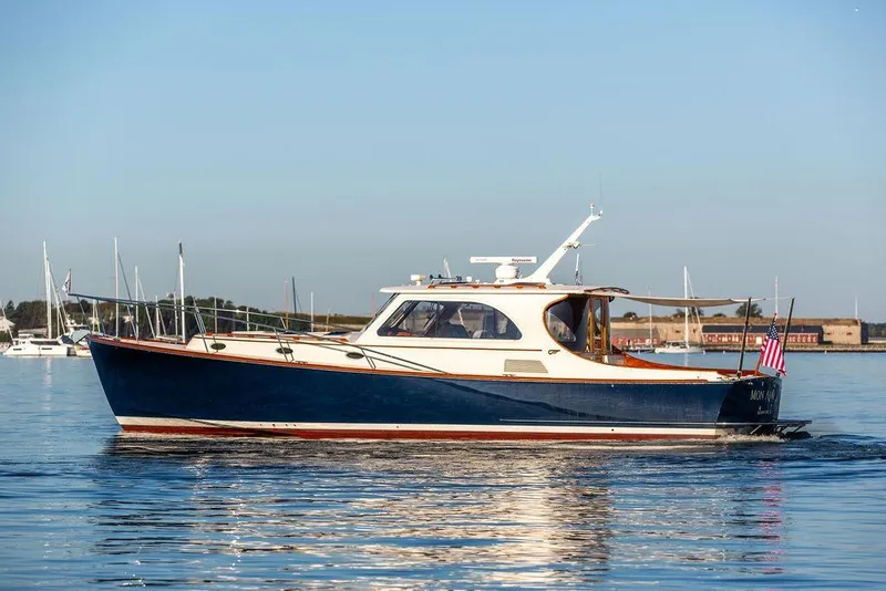 Slide: The Image of Front view of a 2005 Hinckley Talaria 44 yacht reflecting on water. - 4
