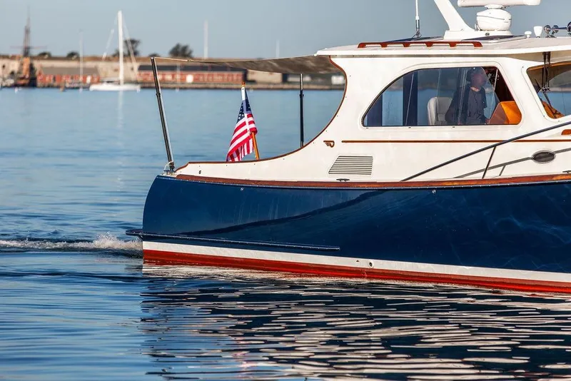 Slide: The Image of Luxurious seating area on a 2005 Hinckley Talaria 44 yacht with striped cushions. - 7