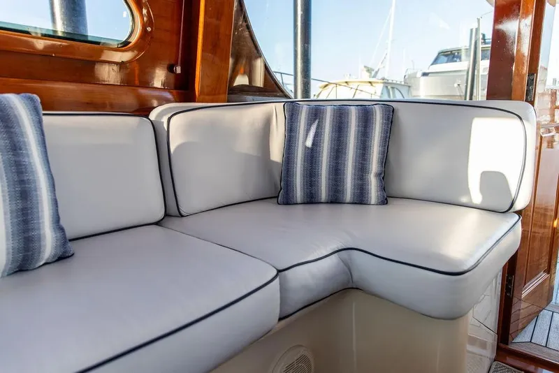 Slide: The Image of Luxurious interior of 2005 Hinckley Talaria 44 yacht with elegant seating and wooden table. - 8