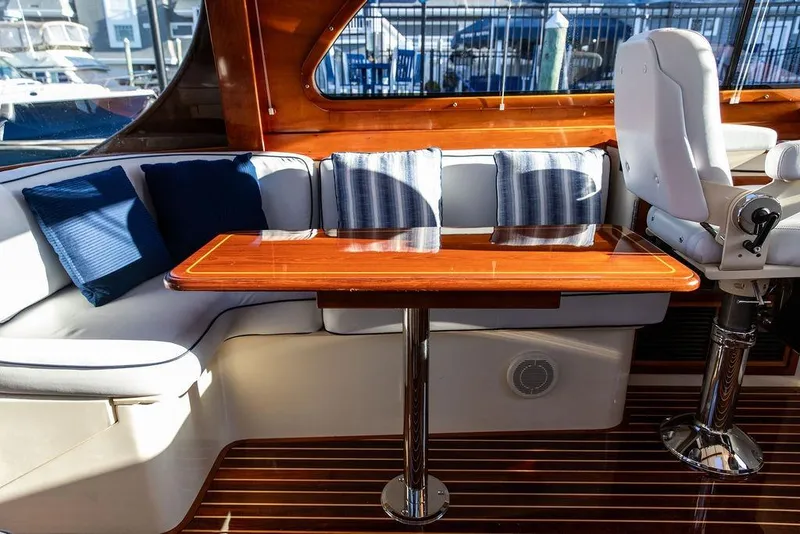 Slide: The Image of Interior of 2005 Hinckley Talaria 44 yacht with elegant wood finish and marina view. - 9
