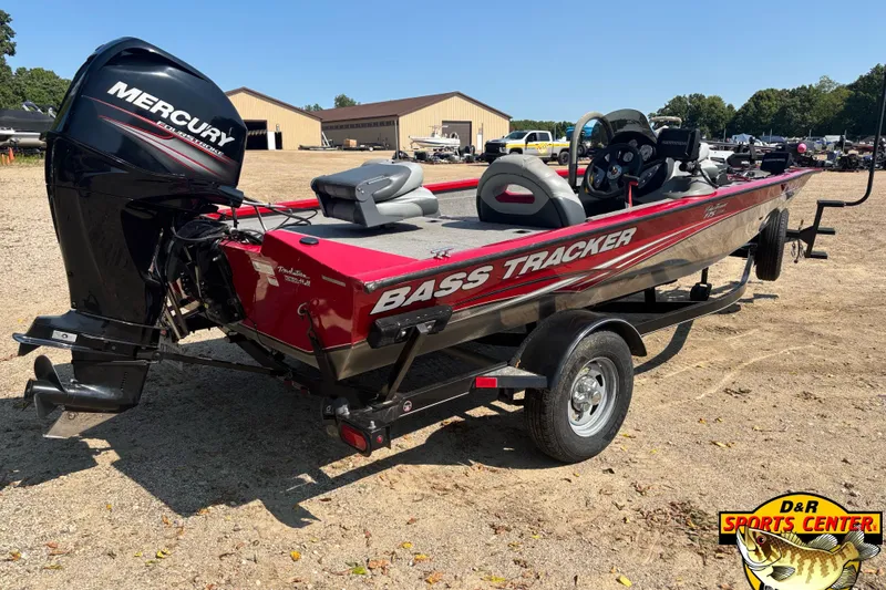 Slide: The Image of 2013 Tracker Pro Team 175 TXW bass boat with Mercury outboard motor on trailer. - 2