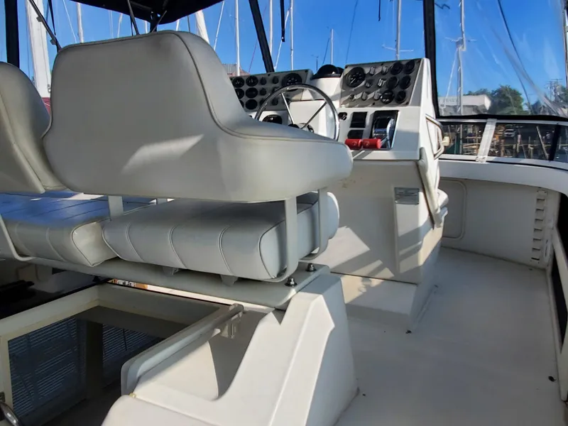 Slide: The Image of Interior helm of 2000 Carver 356 Aft Cabin Motor Yacht with white seating. - 6