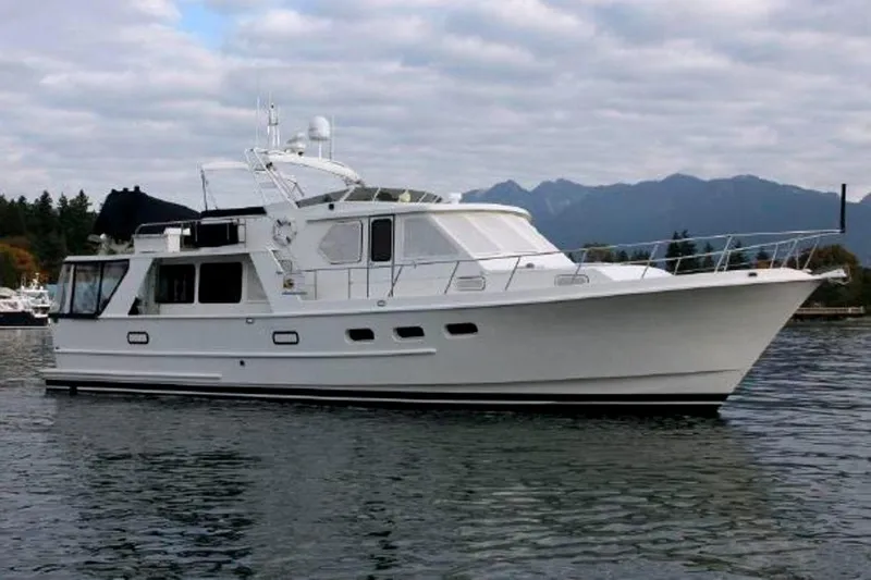 The Image of Custom 1989 Aluminum Pilothouse J Simpson yacht on calm water with mountainous backdrop. - 0