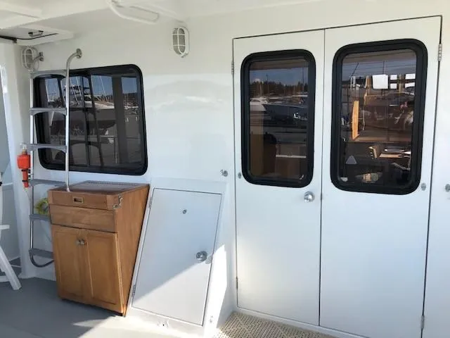 Slide: The Image of Aluminum Pilothouse J Simpson 1989 interior with wooden cabinet and double doors. - 10