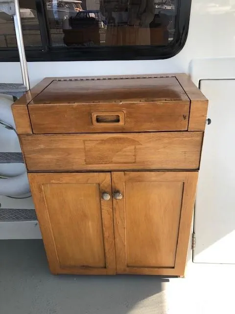 Slide: The Image of Wooden cabinet on 1989 Custom Aluminum Pilothouse J Simpson boat deck. - 11