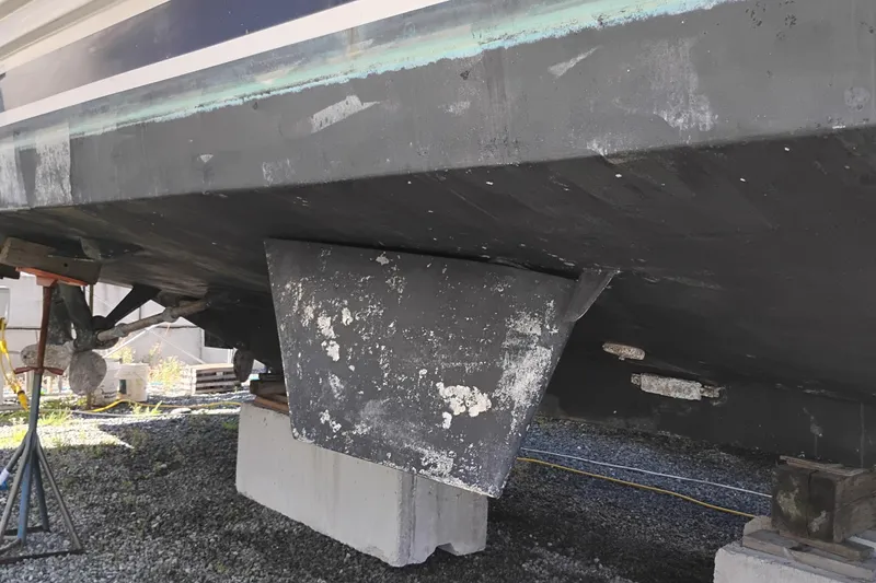 Slide: The Image of 1989 Custom Aluminum Pilothouse J Simpson boat hull on blocks, showing keel and propeller. - 110