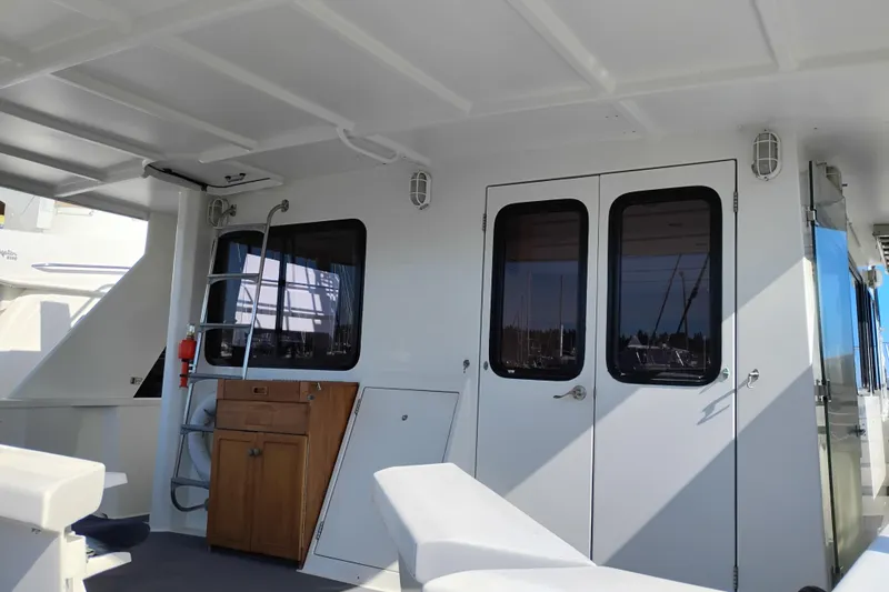 Slide: The Image of 1989 Custom Aluminum Pilothouse J Simpson interior with doors and ladder, featuring nautical design elements. - 13