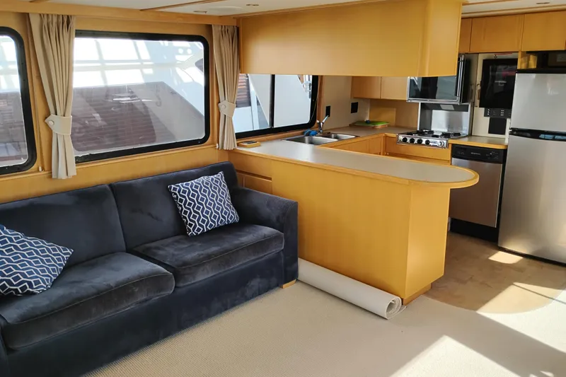 Slide: The Image of Interior of 1989 Custom Aluminum Pilothouse J Simpson with modern kitchen and cozy seating area. - 16