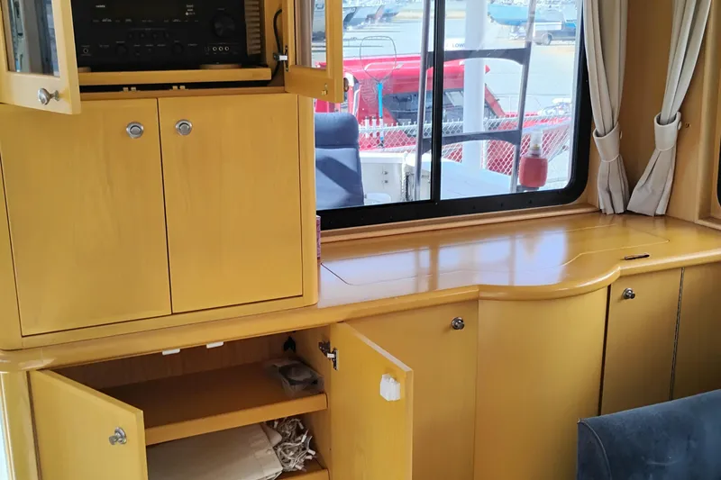 Slide: The Image of Interior of 1989 Custom Aluminum Pilothouse J Simpson with wooden cabinets and window view. - 17