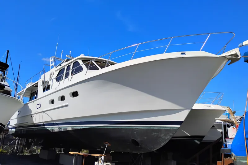 Slide: The Image of 1989 Custom Aluminum Pilothouse J Simpson boat on dry dock under clear blue sky. - 2