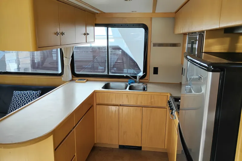 Slide: The Image of 1989 Custom Aluminum Pilothouse J Simpson kitchen with wooden cabinets and stainless steel appliances. - 20