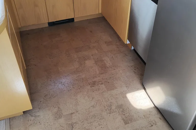 Slide: The Image of Kitchen area of 1989 Custom Aluminum Pilothouse J Simpson with wooden cabinets and cork flooring. - 22