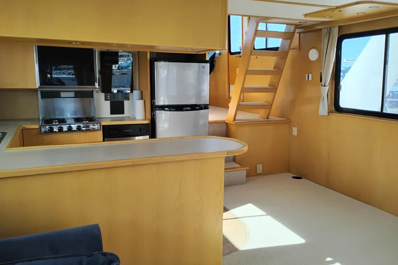 Slide: The Image of Interior of 1989 Custom Aluminum Pilothouse J Simpson with kitchen and wooden staircase. - 23