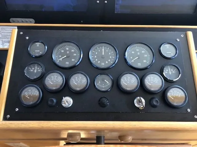 Slide: The Image of Instrument panel of 1989 Custom Aluminum Pilothouse J Simpson with various gauges and controls. - 33